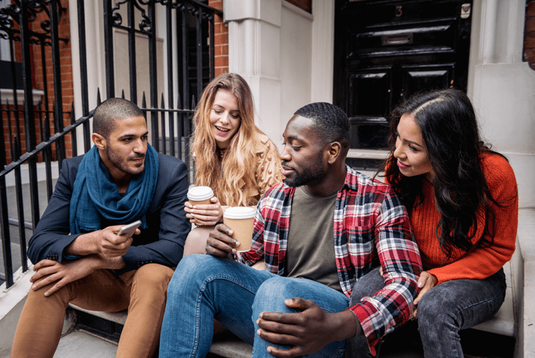 group of people talking outside on steps