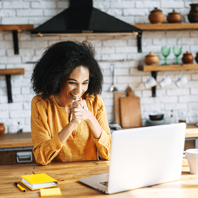 woman looking at her computer talking to someone