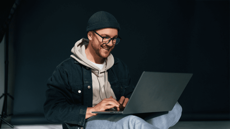 man with computer on black background