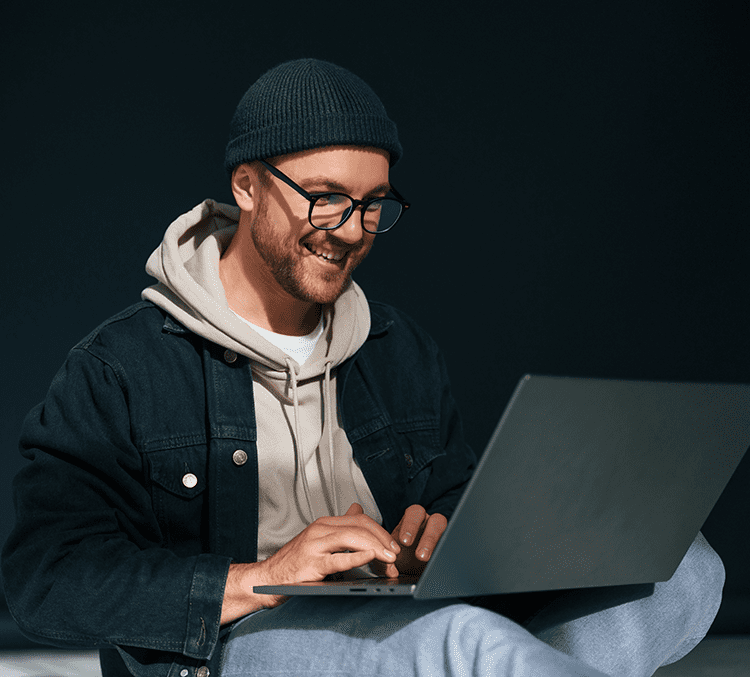 man with computer on black background