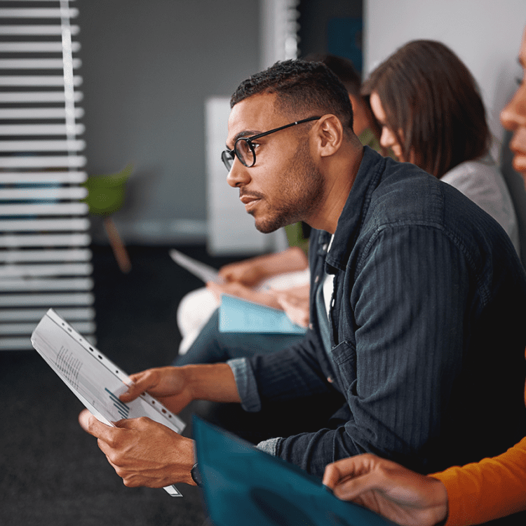 man waiting for job interview with other candidates