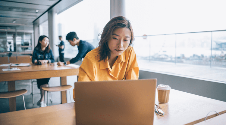 woman sitting at a desk looking at computer