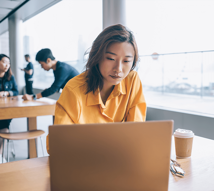 woman sitting at a desk looking at computer